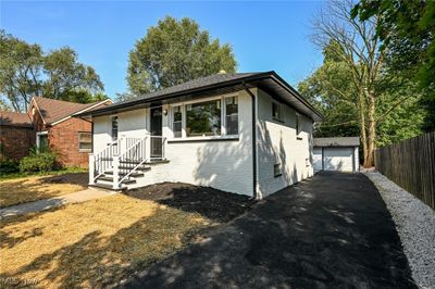 Ranch-style home featuring a garage and an outbuilding | Image 2