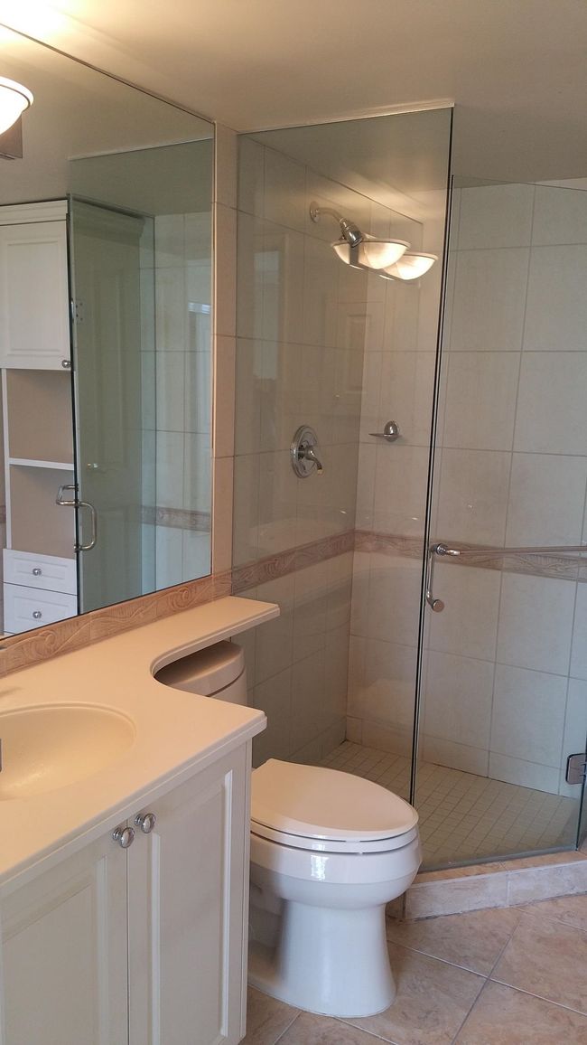 Bathroom featuring vanity, tile patterned floors, toilet, and a stall shower | Image 21