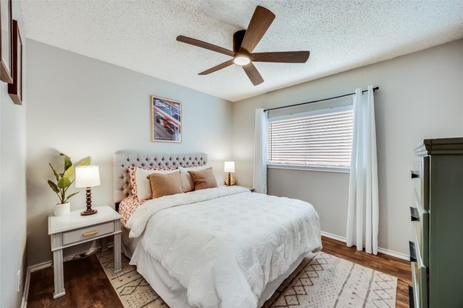 Bedroom featuring a textured ceiling, wood finished floors, baseboards, and a ceiling fan | Image 19