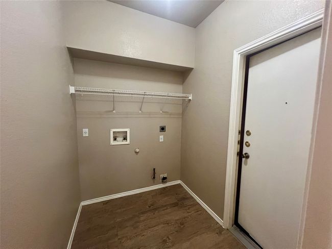 Washroom featuring electric dryer hookup, gas dryer hookup, dark wood-style flooring, and washer hookup | Image 17