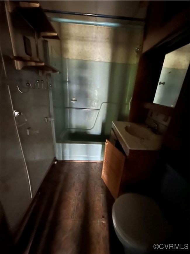 Full bathroom featuring toilet, wood finished floors, vanity, and a shower with door | Image 17