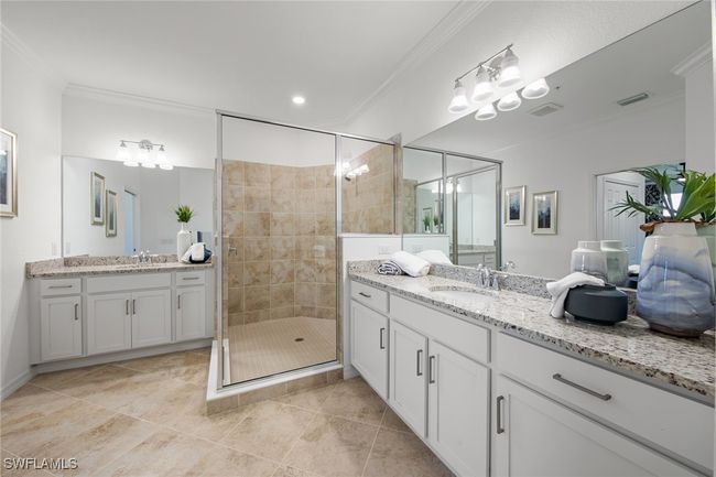 Full bath with a shower stall, a sink, and crown molding | Image 6