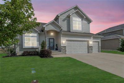 View of front of property with a lawn and a garage | Image 1