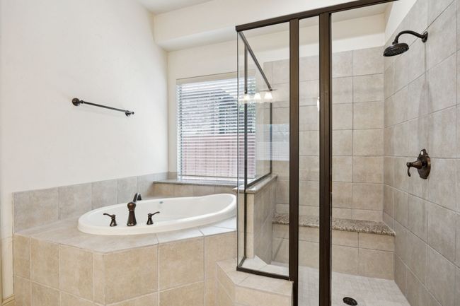 Bathroom with a shower stall and a bath | Image 20