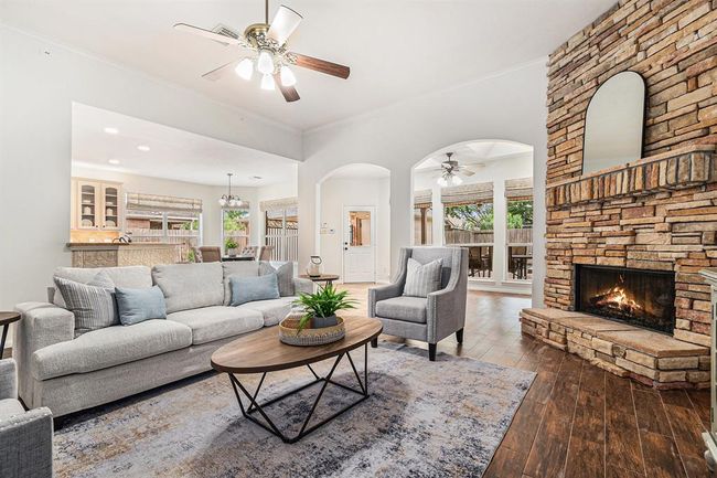 A stunning corner stacked-stone fireplace is sure to create perfect ambiance and warm the hearts of all that gather here! | Image 5