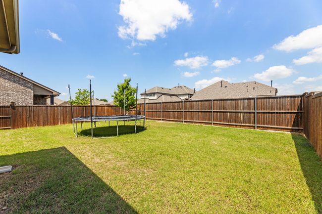 View of yard featuring a trampoline and a fenced backyard | Image 39