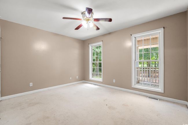 Carpeted empty room featuring baseboards and ceiling fan | Image 6