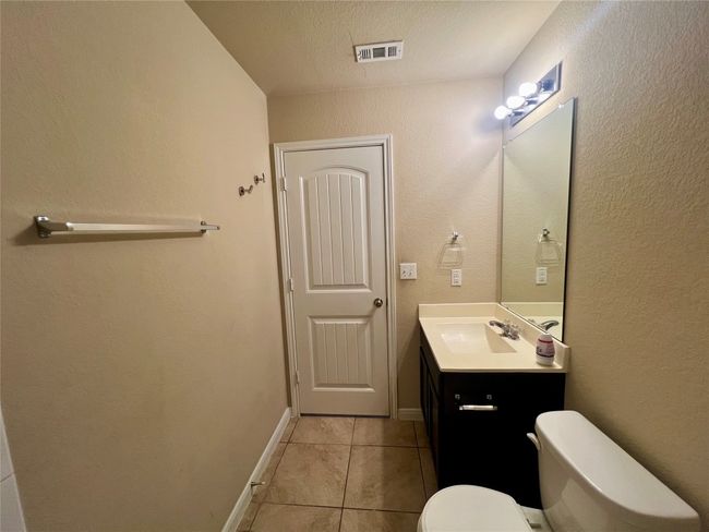 full bath featuring vanity, tile patterned flooring, toilet, and baseboards | Image 8
