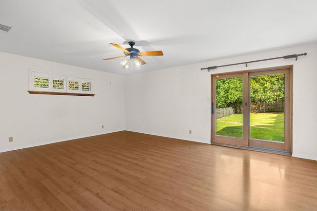 Spare room featuring wood finished floors and ceiling fan | Image 5
