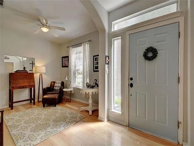 Foyer with healthy amount of natural light, ceiling fan, and light wood-style floors | Image 6