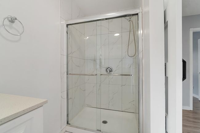 Bathroom with wood finished floors, a shower stall, and vanity | Image 27