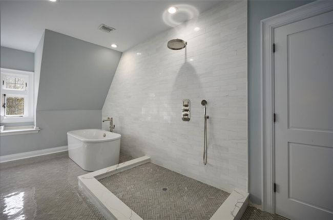 Full bathroom with baseboards, recessed lighting, tiled shower, a soaking tub, and visible vents | Image 23