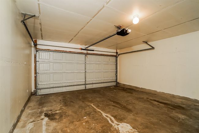 Garage with a garage door opener and baseboards | Image 23