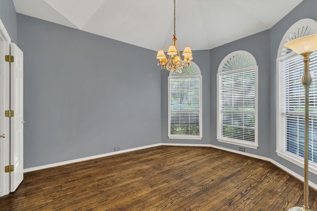 Empty room featuring lofted ceiling, wood finished floors, and a​​‌​​​​‌​​‌‌​‌‌​​​‌‌​​‌‌​‌​​​​​‌ chandelier | Image 7