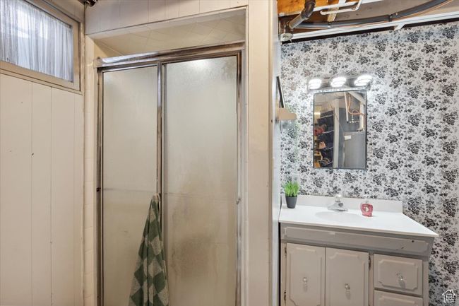 Bathroom featuring wallpapered walls, a stall shower, and vanity | Image 23