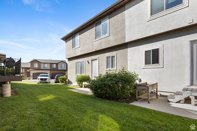 Rear view of property featuring a yard and stucco siding | Image 31