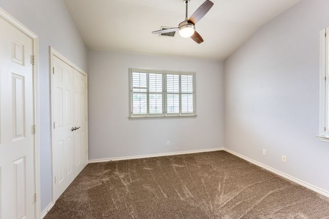 Unfurnished bedroom with carpet, a ceiling fan, and a closet | Image 19