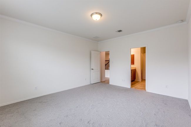 Unfurnished bedroom featuring baseboards, visible vents, light colored carpet, and ornamental molding | Image 15
