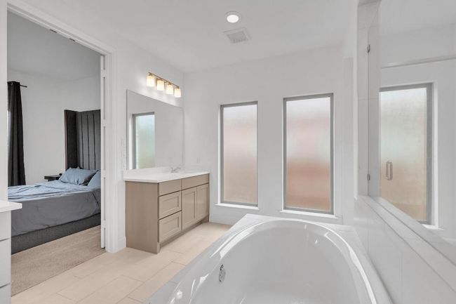 Bathroom with vanity, a garden tub, ensuite bath, and healthy amount of natural light | Image 32
