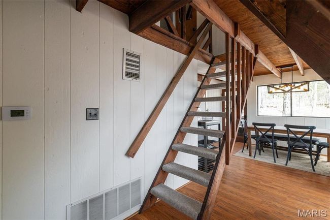 Stairway with visible vents, beamed ceiling, and wood finished floors | Image 29