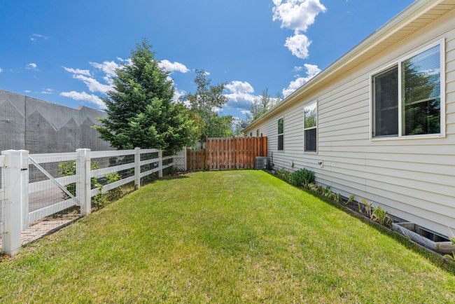 Fenced back yard with access to paved bike and walking trail. | Image 16