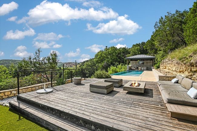 Deck featuring a gazebo and an outdoor living space with a fire pit | Image 32
