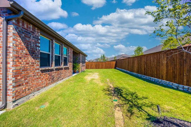 View of fenced backyard | Image 26