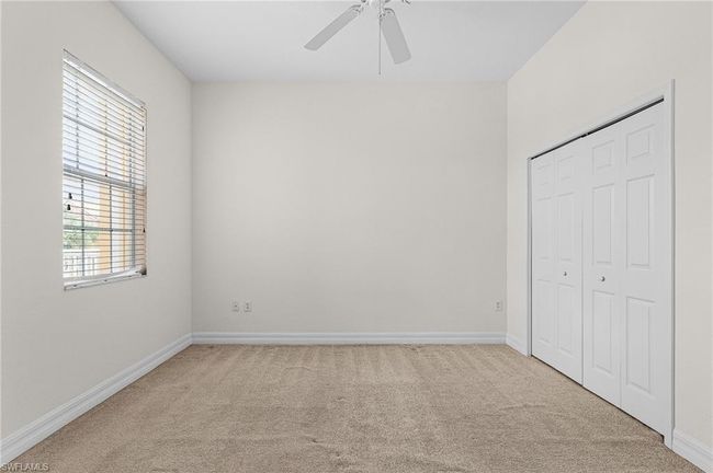 Unfurnished bedroom featuring light carpet, a closet, and ceiling fan | Image 18
