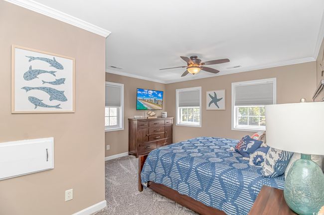 Bedroom featuring carpet flooring, crown molding, and ceiling fan | Image 32