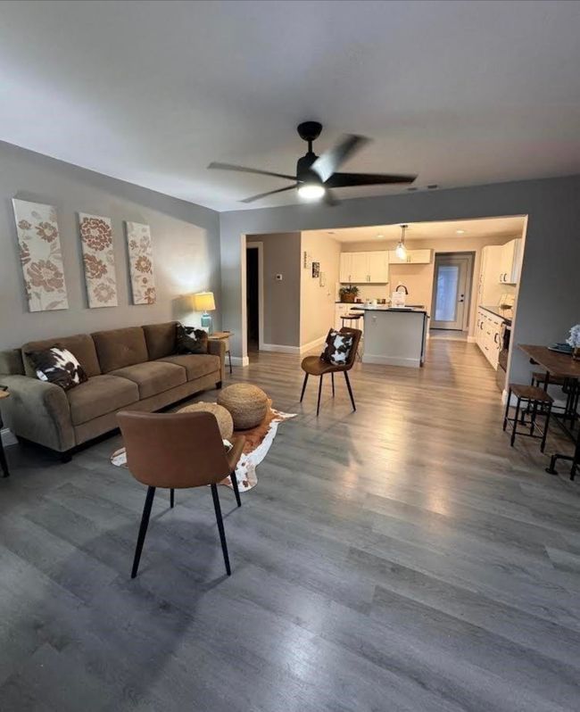 Living room featuring wood finished floors, baseboards, and ceiling fan | Image 5