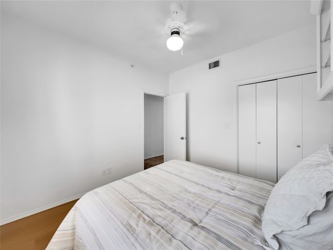 Bedroom with a closet, wood finished floors, a ceiling fan, and baseboards | Image 15