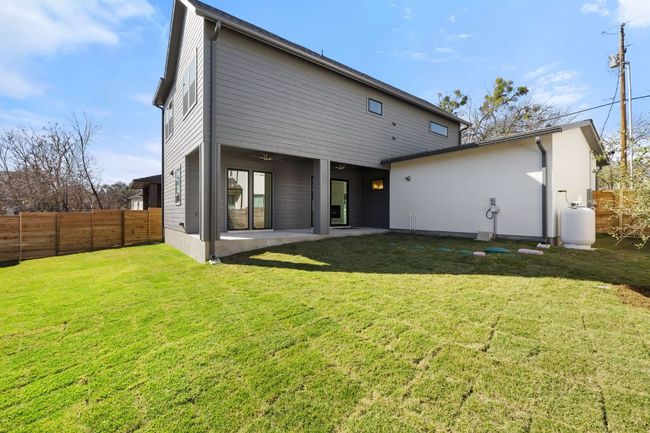 Rear view of property featuring a yard, a patio area, fence, and ceiling fan | Image 32