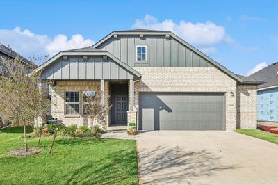 View of front of house with a front lawn and a garage | Image 1