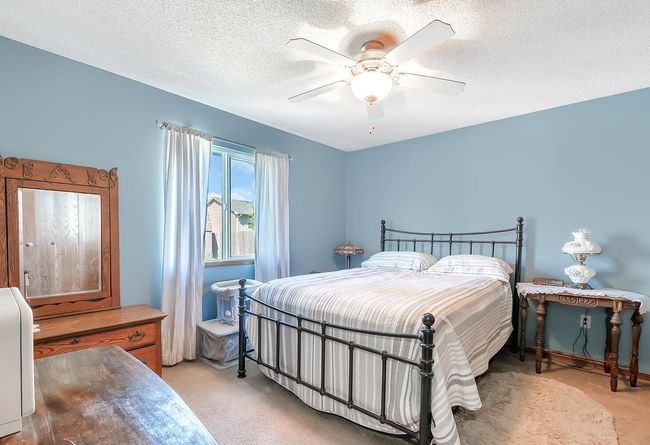Bedroom with light colored carpet, and a ceiling fan | Image 15