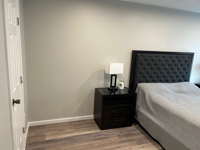 Bedroom with wood finished floors and baseboards | Image 36