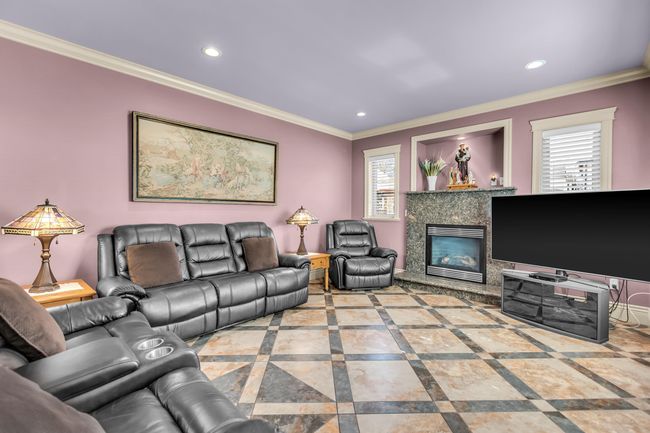 Living room featuring ornamental molding, a fireplace, recessed lighting, and plenty of natural light | Image 16