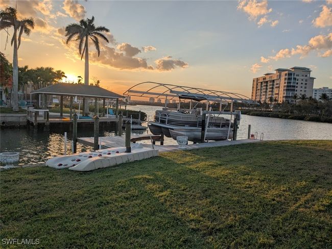 View of dock featuring boat lift, a water view, and a lawn | Image 4