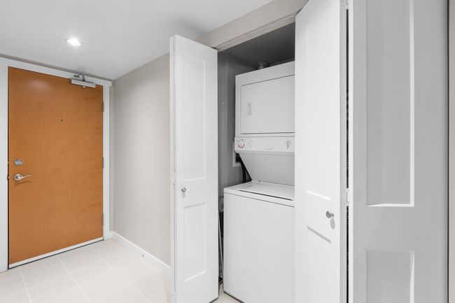 Laundry room featuring baseboards, stacked washer / dryer, and laundry area | Image 18