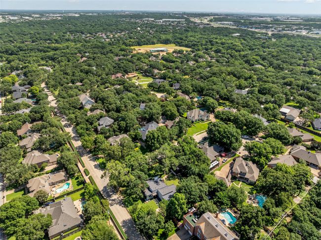 Aerial view of residential area featuring a forest | Image 5