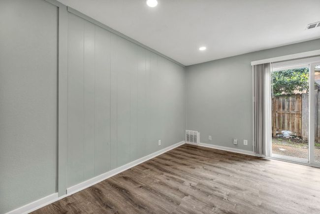 Unfurnished room with wood finished floors, recessed lighting, and baseboards | Image 8