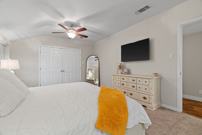 Bedroom with a closet, ceiling fan, and carpet | Image 27