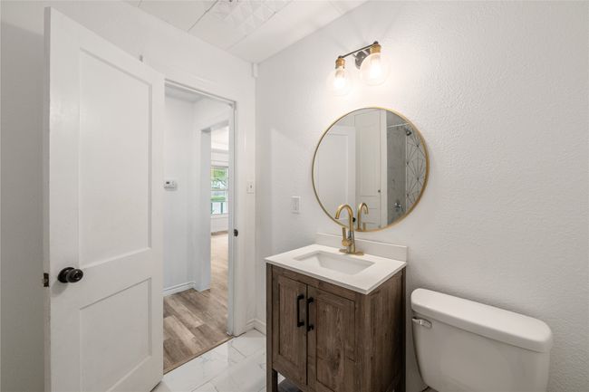 Bathroom featuring vanity, toilet, and marble finish floors | Image 14