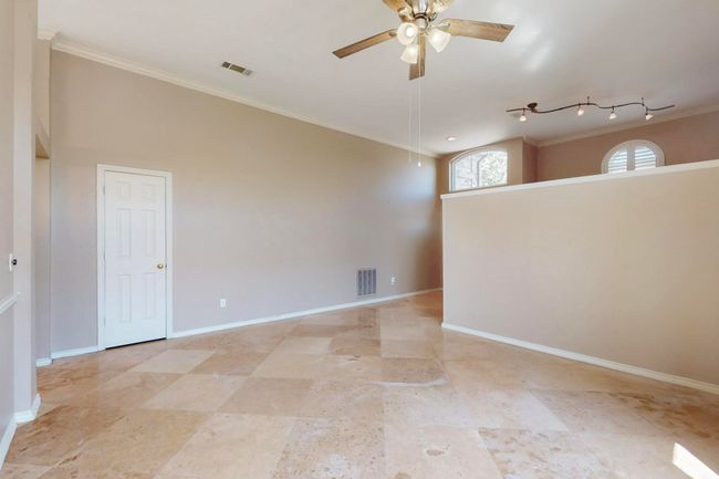 Empty room featuring crown molding, baseboards, a ceiling fan, and visible vents | Image 5
