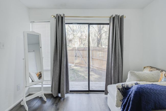Sitting/dressing area in primary bedroom with patio access | Image 35