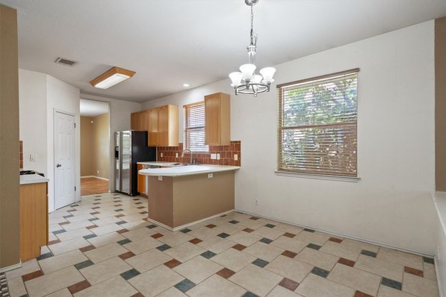 Breakfast area with tile and chandelier | Image 14