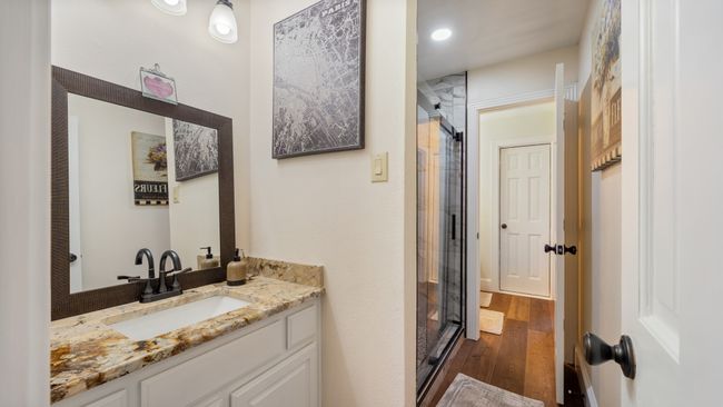 Bathroom featuring a shower stall, vanity, and hardwood / wood-style flooring | Image 27