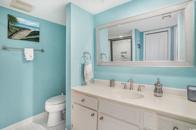 Bathroom with vanity, tile patterned floors, and a shower | Image 21
