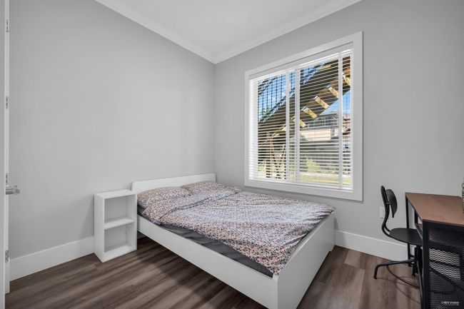 Bedroom featuring ornamental molding, multiple windows, and dark wood-style flooring | Image 24