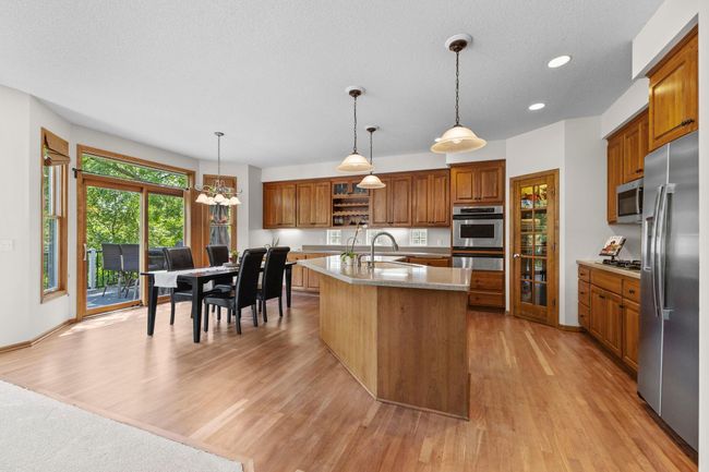 Look at those beautiful wood floors showing eat in kitchen with access to deck | Image 17