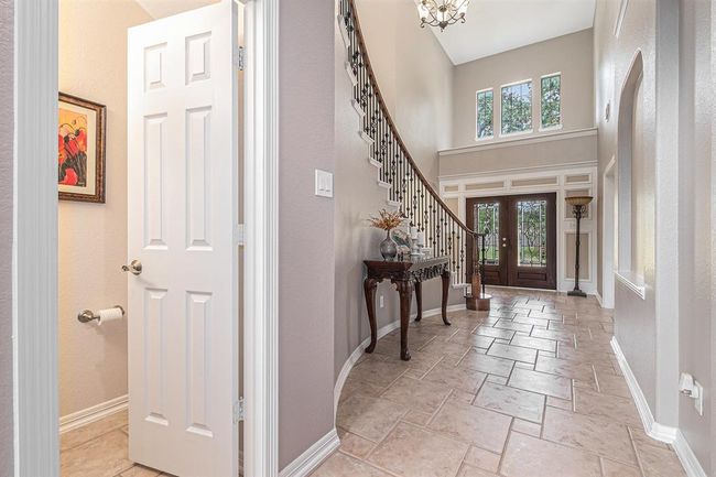 Wonderfully designed ceramic tile flooring steals the show in this entry, as the warm light flows into the space! | Image 5